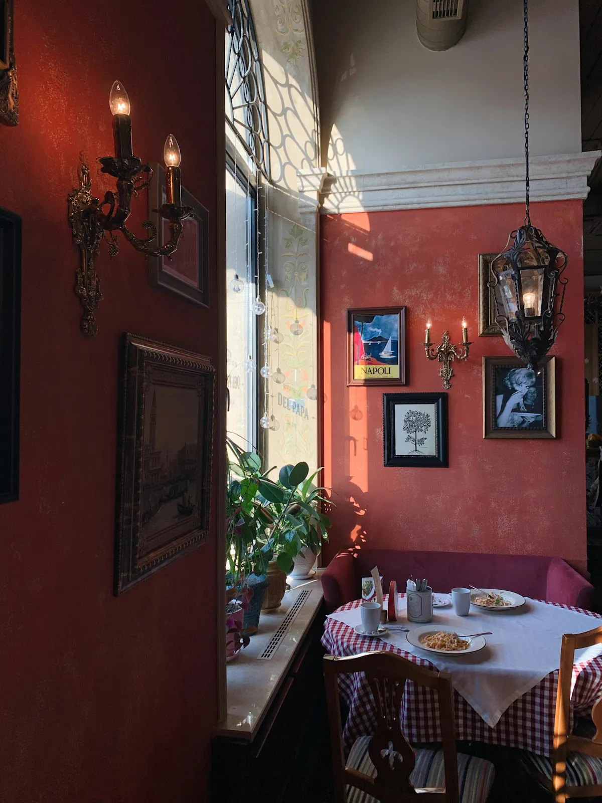 The red dining room with candles on the wall